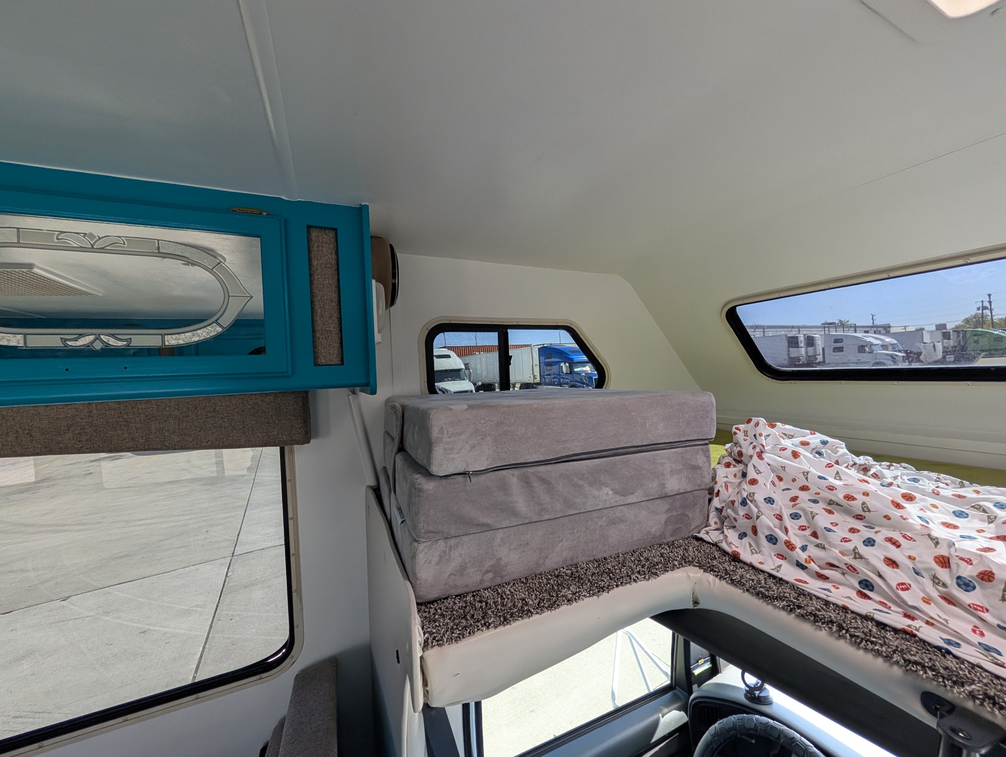 Cab-over cabinets and cushion